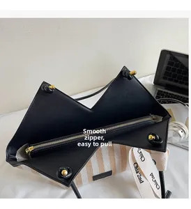 Top view of striped canvas tote with black leather lining and smooth gold metal zipper detail