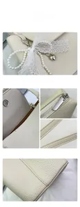 Detail of lychee pattern leather, magnetic buckle, and pearl lace bow on tote bag