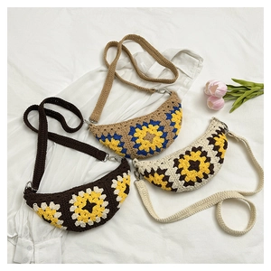 Detailed macro of handmade crochet crossbody bags with floral sunflower knit patterns