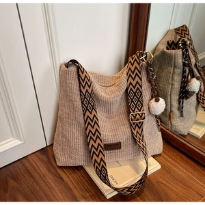 Detail view of the handwoven tote bag with adjustable geometric patterned shoulder strap