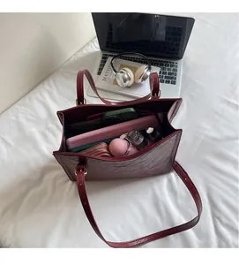Top view of spacious burgundy tote bag interior showing capacity for daily essentials