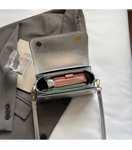 Top view of metallic silver crossbody bag interior showing spacious storage for phone