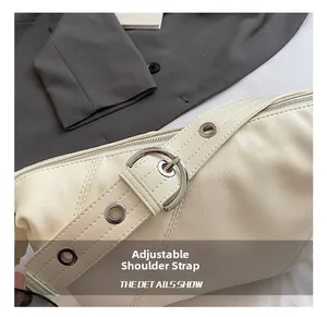 Détail de la bandoulière réglable en cuir crème avec boucle en métal argenté