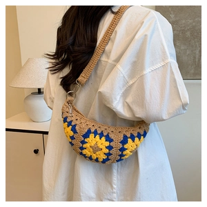 Detailed close-up of handmade crochet sunflower crossbody bag with woven wide strap