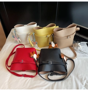 Detailed row of five lychee grain bucket bags in assorted colors with Pegasus charms