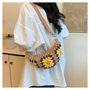 Detail of bohemian crochet crescent bag featuring yellow sunflower patterns and a wide strap