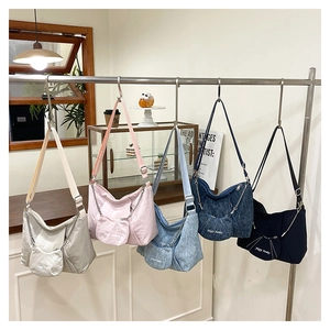 Detail of multi-color pleated canvas tote bags with adjustable straps and round coin purses
