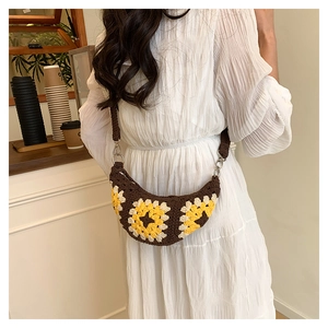 Detail of bohemian crochet sunflower bag with crescent shape and woven strap