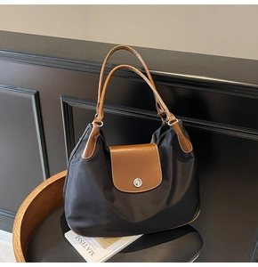 Classic large black nylon tote bag with brown leather handles and silver button detail