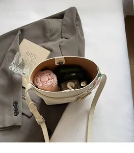 Internal view of beige lychee textured bucket bag showing ample space for essentials