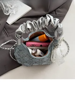 Macro view of blue denim bag interior showing spacious capacity for phone and cosmetics