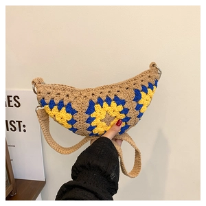 Detail of bohemian handmade crochet sunflower crescent bag with textured cotton stitching