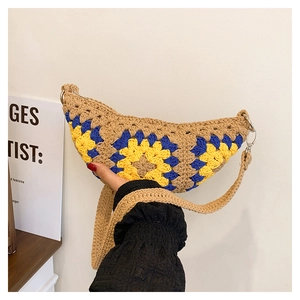 Detail of bohemian handmade crochet bag with sunflower pattern and metal buckle closure