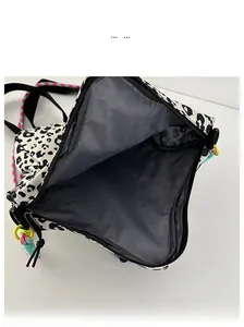 Internal view of leopard print canvas bag showing gray lining and zipper closure
