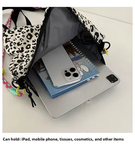 Detailed top view of leopard print bag showing large capacity for iPad and phone