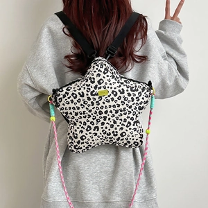 Detail of star-shaped backpack featuring leopard print and colorful woven cords
