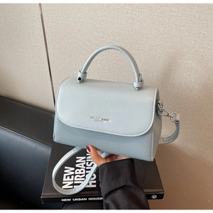 Close-up of light blue shoulder bag with mixed smooth and lychee leather textures