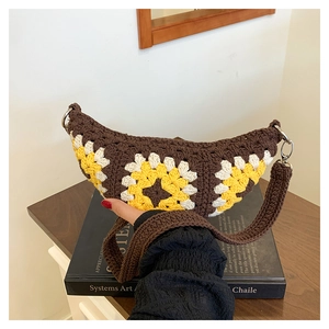 Detail of bohemian crochet crossbody bag with floral patterns and woven strap