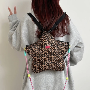 Detail of leopard print star-shaped backpack with colorful ropes and adjustable straps