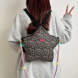 Leopard print star-shaped backpack with pink label and colorful woven rope details