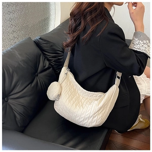 Detail of off-white crescent dumpling bag with pleated texture and round coin purse