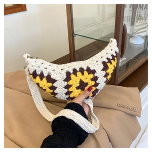 Detail of bohemian crochet crescent bag with yellow sunflower patterns and metal ring