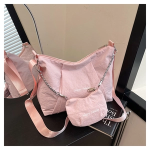 Detail of pink pleated nylon tote bag with silver chain and Happy Sunday print detail