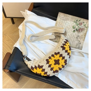 Detailed close-up of handmade crochet bag with sunflower pattern and metal buckle