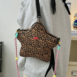 Detail of star-shaped leopard print bag with colorful braided cords and wide strap
