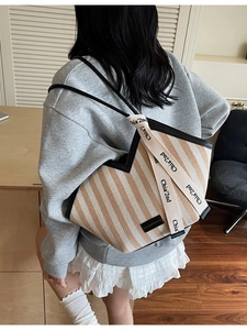 Brown striped canvas tote bag with shoulder strap and ribbon detail for women