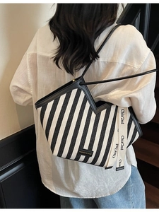 Large striped canvas tote bag with leather straps and decorative woven ribbon for women