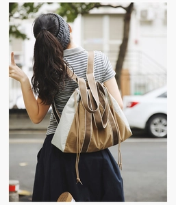 Detailed back view of a high-capacity drawstring canvas tote bag in khaki and grey colors