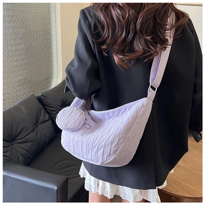 Close-up of a light purple pleated crescent bag with matching small round coin pouch