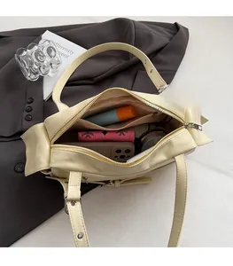 Detail view of the spacious inner compartments of this stylish cream pillow bag