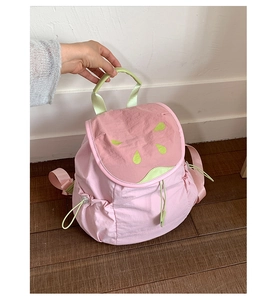 Detailed view of the pink watermelon pattern and drawstring on the girl's backpack