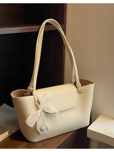 Large beige leather tote bag with lace pearl charm and spacious shoulder straps