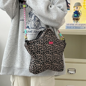 Detail of star-shaped leopard print shoulder bag with colorful braided rope strap