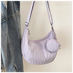 Close-up of light purple pleated crescent bag with detachable mini round coin purse