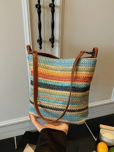 Colorful striped woven straw bucket bag with brown leather strap for summer vacation