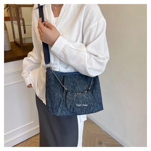 Detail of dark blue denim tote bag with Happy Sunday mini pouch and silver chain strap