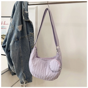 Detail of light purple pleated crossbody crescent bag with matching round coin purse pouch