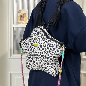 Detail of star-shaped leopard print backpack with vibrant colorful braided rope straps
