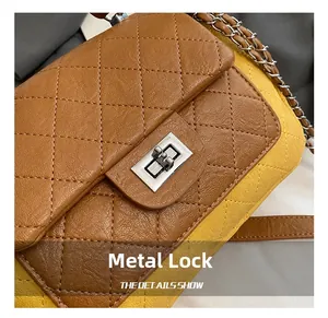 Detail of silver hardware twist lock and quilted leather texture on crossbody bag