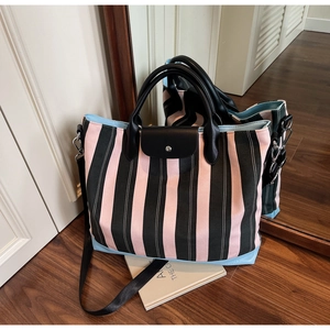 Detailed close-up of striped canvas tote bag with pink and green vertical stripes