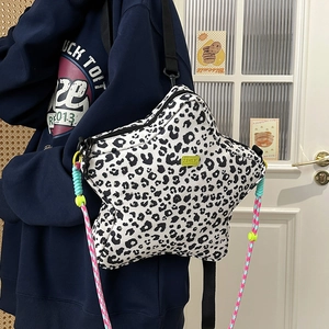 Detail of star-shaped crossbody bag with leopard print and multi-color rope strap