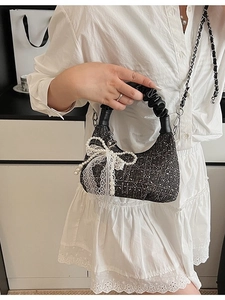 Elegant black tweed half-moon handbag with pearl lace bow and chain shoulder strap