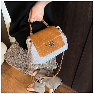 Brown and gray quilted crossbody bag with metal chain strap shown on a model