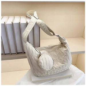 Detail of off-white pleated hobo bag with adjustable strap and mini round coin purse