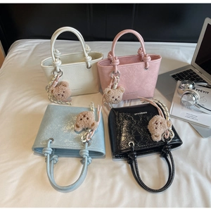 Mini tote bags with crinkle texture and plush bear charms in four vibrant colors