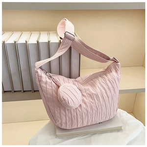 Detail of pink pleated hobo bag texture with matching mini round coin purse attachment